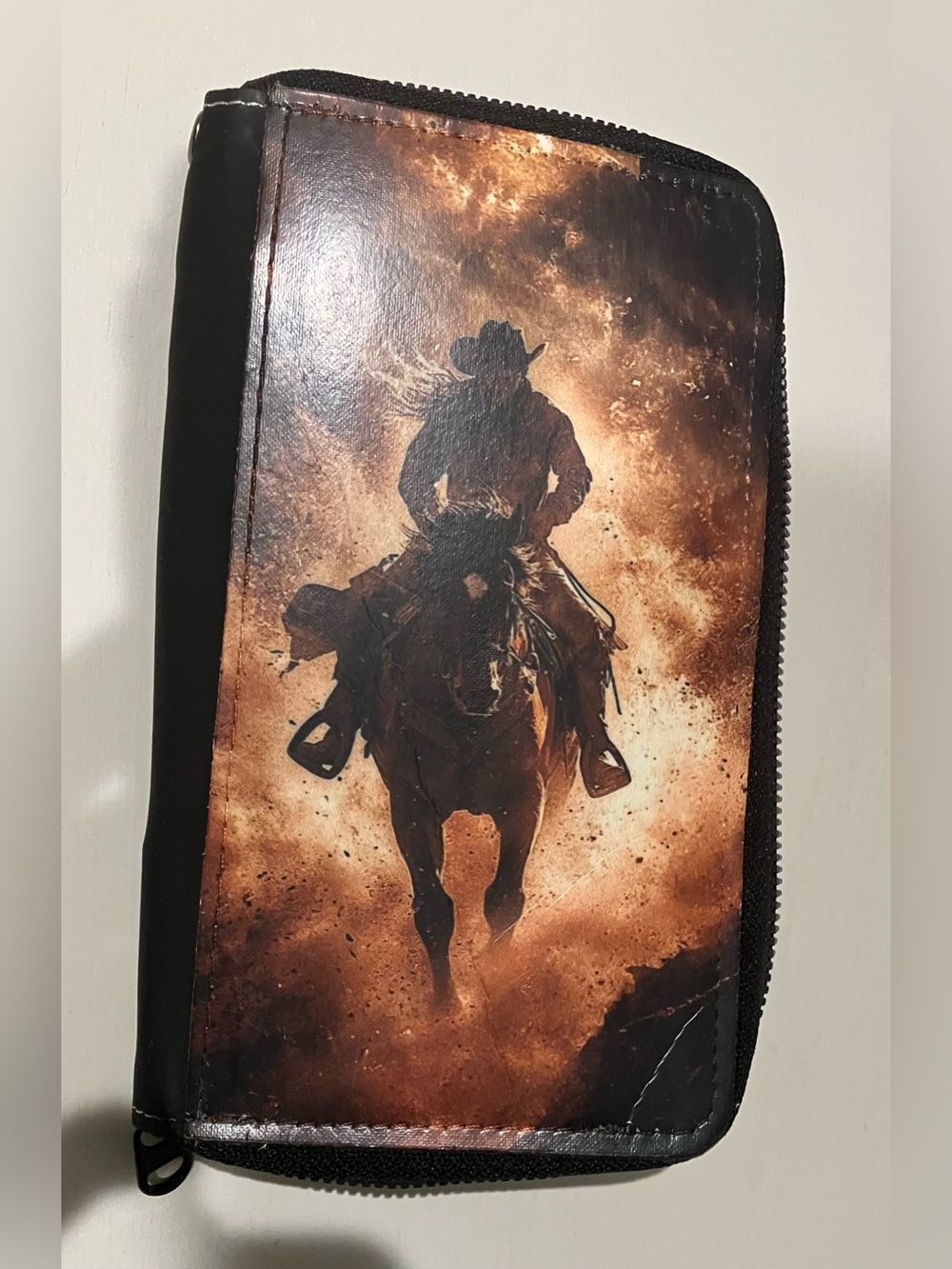 Western-themed zip-around wallet cowboy riding horse sunset